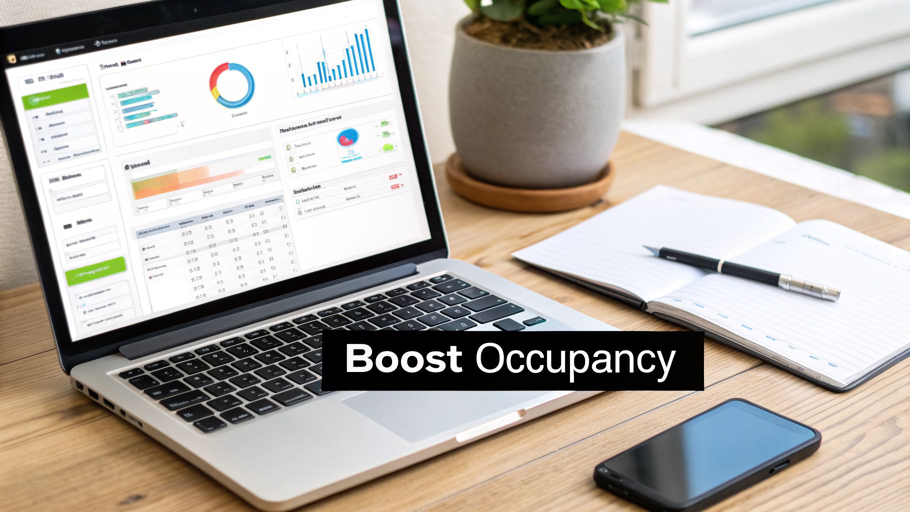 Laptop showing business analytics and charts, with 'Boost Occupancy' text, alongside a notebook, pen, and smartphone.