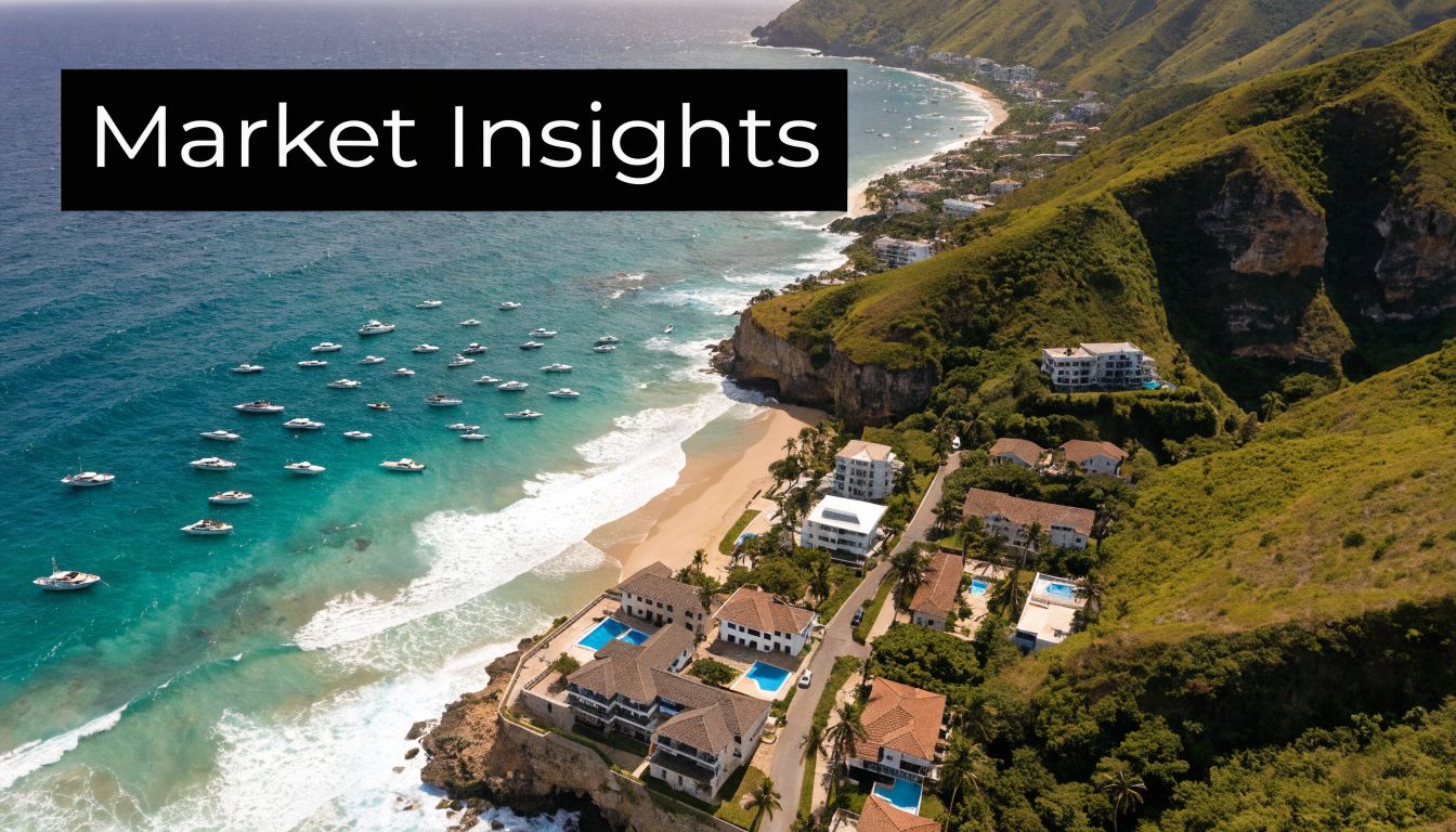 Aerial view of luxury coastal villas overlooking a beach with boats in the Dominican Republic.