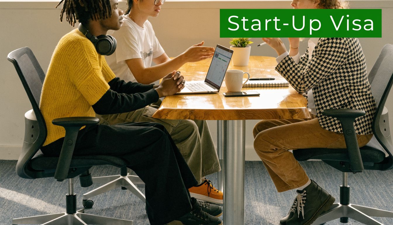 A diverse team of professionals collaborating around a wooden desk while reviewing a laptop in an office.