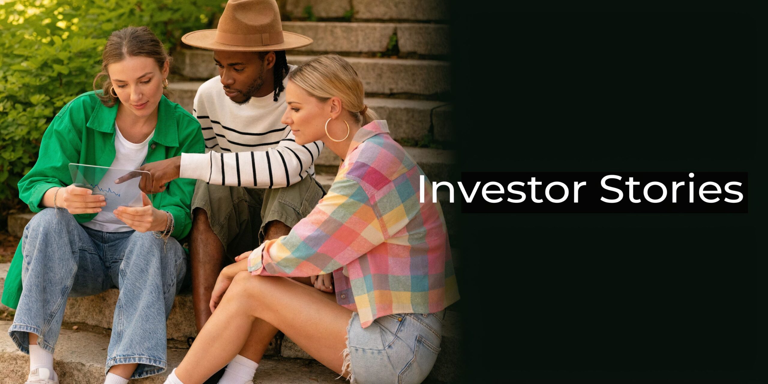 A diverse group of three young adults sitting on stone steps reviewing a digital investment chart together.