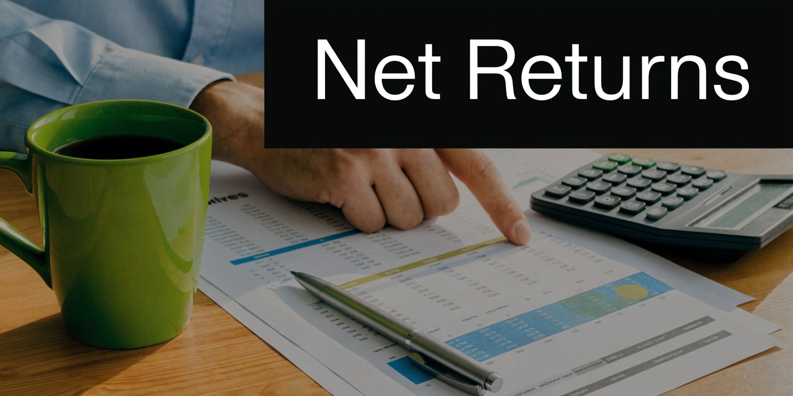 A close-up of a person analyzing financial documents with a calculator and coffee on a desk.