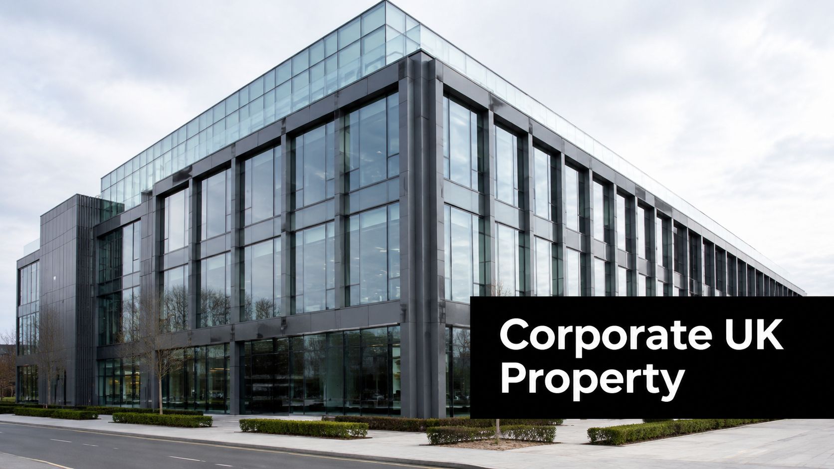 A modern glass-paneled corporate office building located in the United Kingdom on a cloudy day.