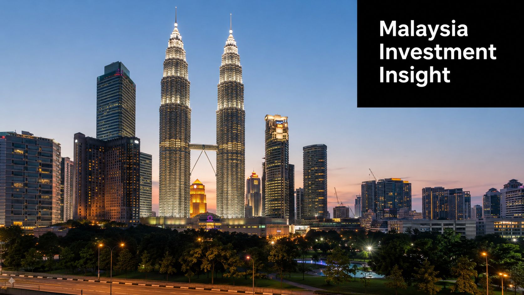 The Petronas Twin Towers illuminate the Kuala Lumpur city skyline during a beautiful sunset in Malaysia.